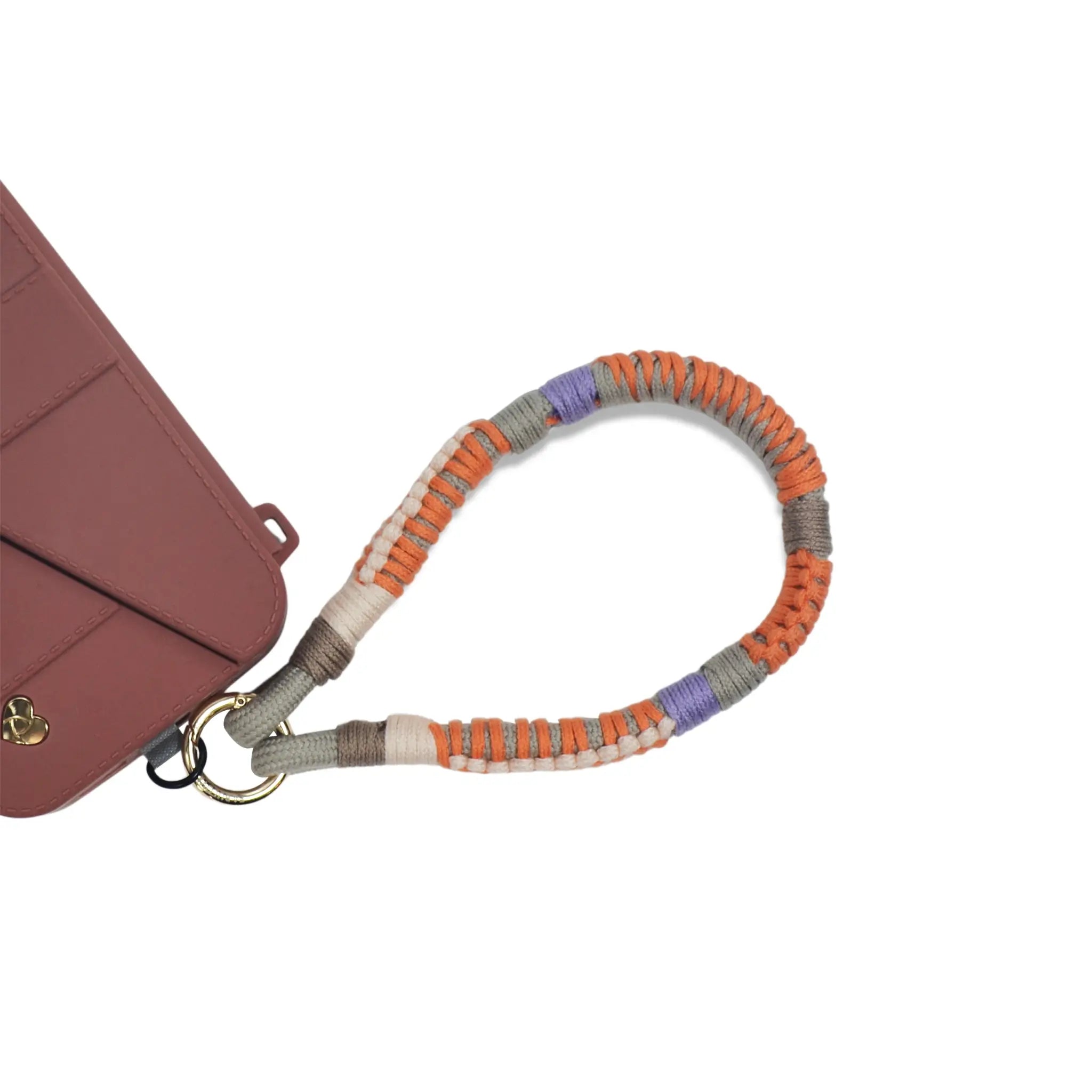 Phone secured to charging port via strap card using Amber Haze biodegradable phone strap