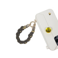 Handle accenting phone case edge as functional decor in caramel brown