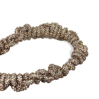 Luxury hand-braided crystal strands with golden clasp close-up