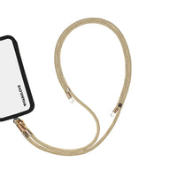 Adjustable golden phone crossbody strap connected to iPhone charging port