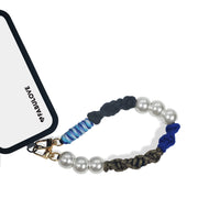 Hades strap attached to phone case charging port using strap card