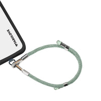 Adjustable mint green phone strap connected to iPhone charging port