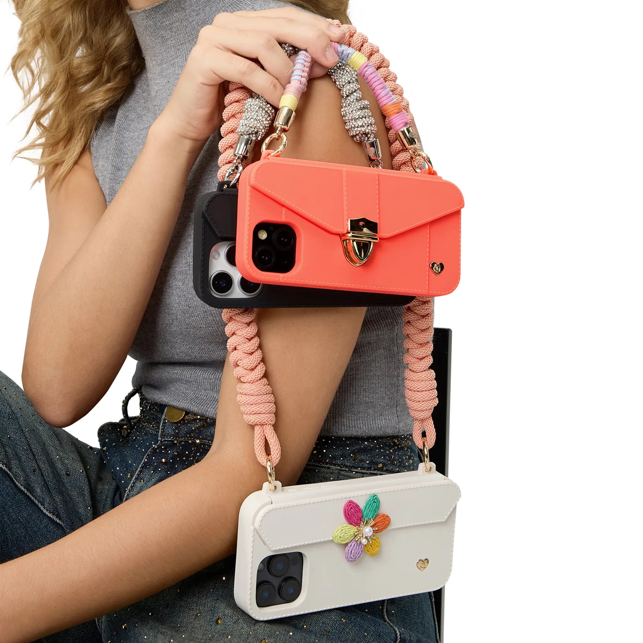 Woman showcasing mix-and-match options for purse cases with interchangeable straps and ornaments.