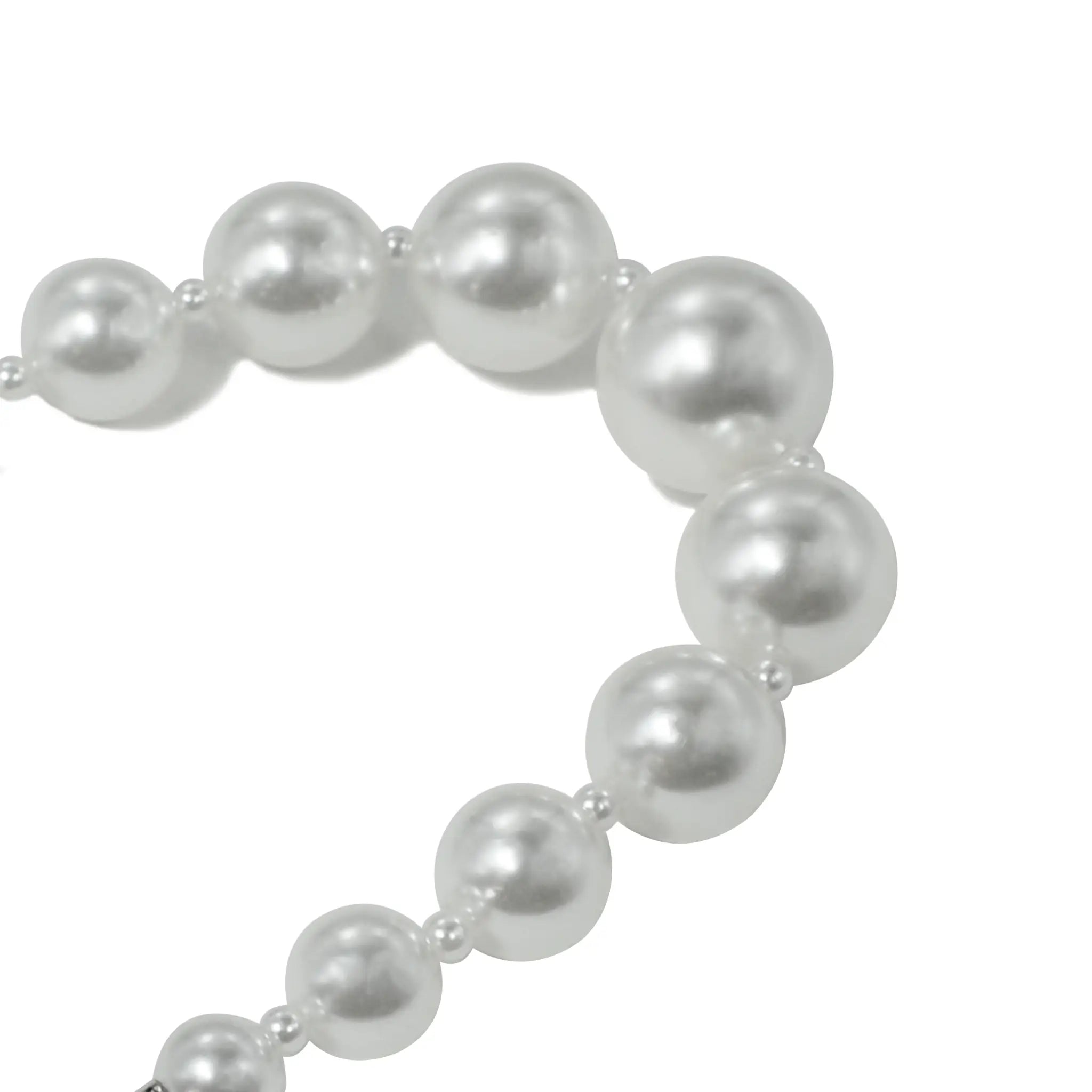 Close-up of small pearl beads on bracelet, highlighting fine details.