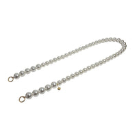 Side view of elegant pearl rope strap with separated golden clasps.
