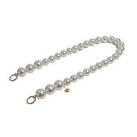 Side angle of pearl shoulder strap with golden clasps separated, highlighting versatility.