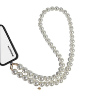 Pearl strap secured to phone case charging port via strap card, ideal as a bag or crossbody accessory