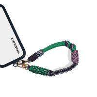 Wristlet strap attached to phone case charging port for secure hold