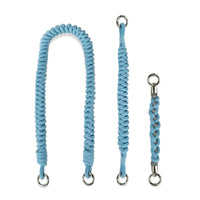 Fully separated hand-braided straps: Shoulder carry length (peacock blue), wrist safety loop, mini handle charm in flatlay arrangement