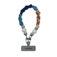 Front view of Titan color hand-braided wristlet hanging with strap card attachment