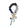 Hades handle in hand-braided TENCEL™ hanging with charm details