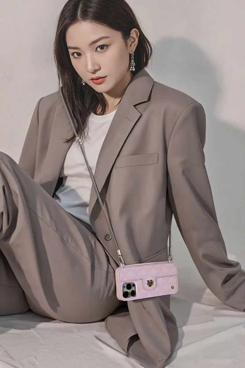 Asian professional with silver crossbody strap & Flamingo purse. LOVE, BRAIDED INTO EVERY DETAILS.