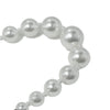Close-up of small pearl beads on bracelet, highlighting fine details.
